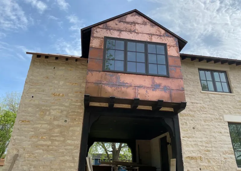 Copper metal panel facade on a stone building for Skylight Installation in Harrison